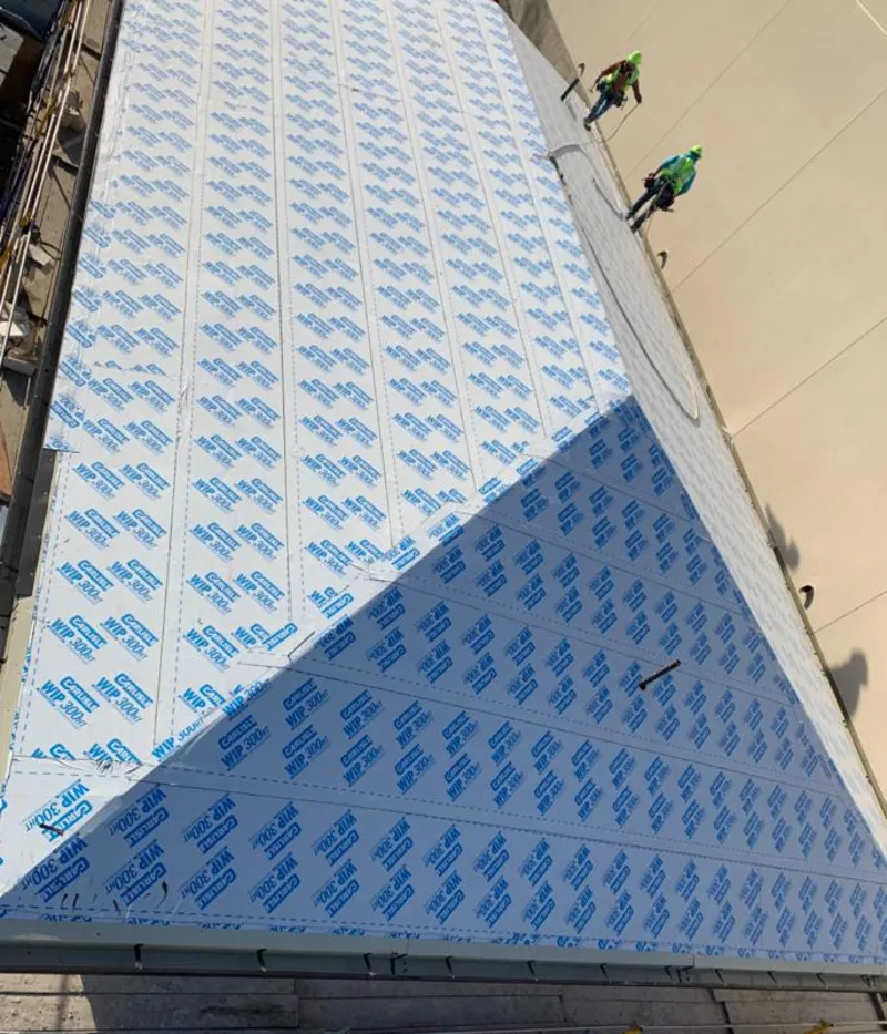 Professional roofers installing underlayment on a metal roof in Princeton